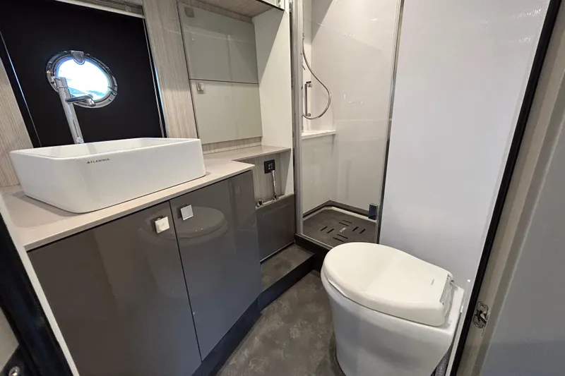  Yacht Photos Pics Modern bathroom in 2023 Cranchi 60 ST yacht with sleek fixtures and shower.