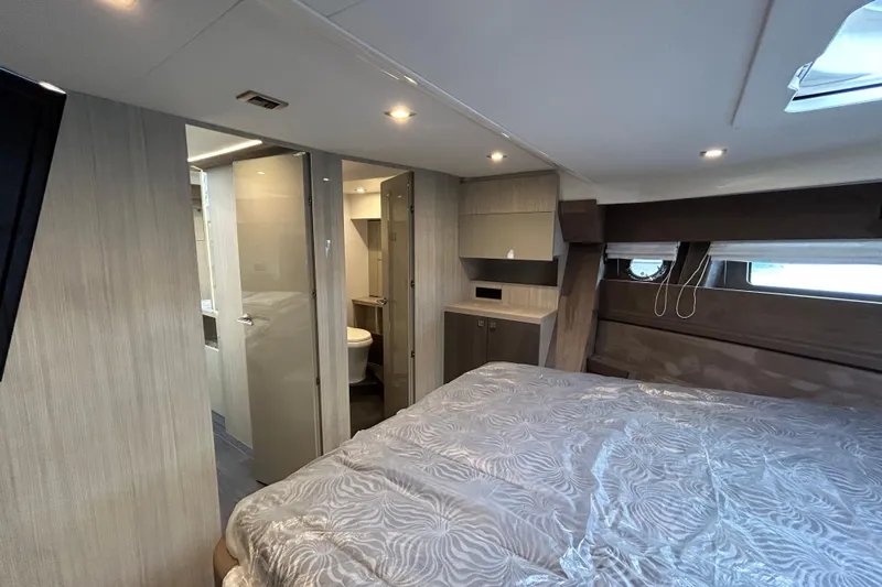  Yacht Photos Pics Luxurious interior of 2023 Cranchi 60 ST yacht with modern bedroom and ensuite bathroom.