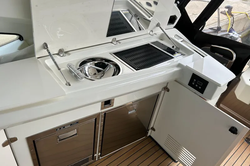  Yacht Photos Pics Luxury yacht kitchen area on 2023 Cranchi 60 ST, featuring modern appliances and sleek design.