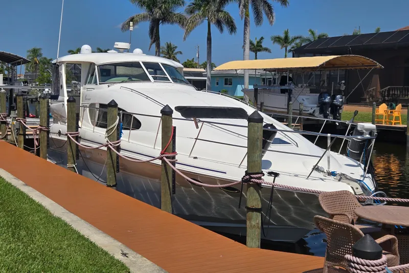 Mojito Yacht Photos Pics 2004 Sea Ray 480 Motor Yacht docked by palm trees, sunny day.