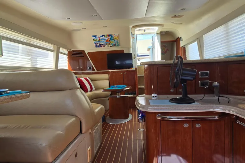Mojito Yacht Photos Pics Luxurious interior of 2004 Sea Ray 480 Motor Yacht with leather seating and wood finishes.