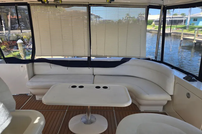 Mojito Yacht Photos Pics 2004 Sea Ray 480 Motor Yacht interior with white seating and wooden flooring.