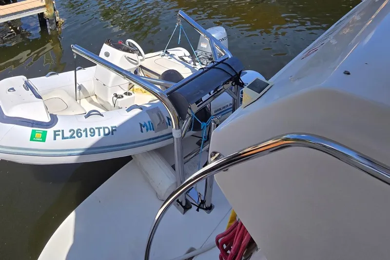 Mojito Yacht Photos Pics 2004 Sea Ray 480 Motor Yacht with attached dinghy on water.