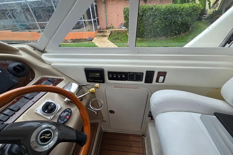 Mojito Yacht Photos Pics Interior helm of 2004 Sea Ray 480 Motor Yacht with steering wheel and control panel.