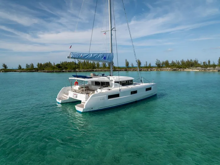 Watercolor Yacht Photos Pics 2023 Lagoon 46 catamaran sailing in clear turquoise waters.
