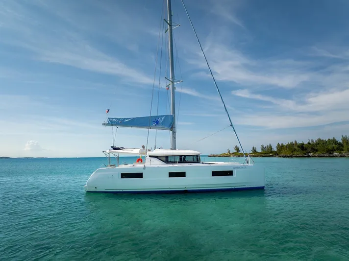 Watercolor Yacht Photos Pics 2023 Lagoon 46 catamaran sailing on clear turquoise waters under a blue sky.
