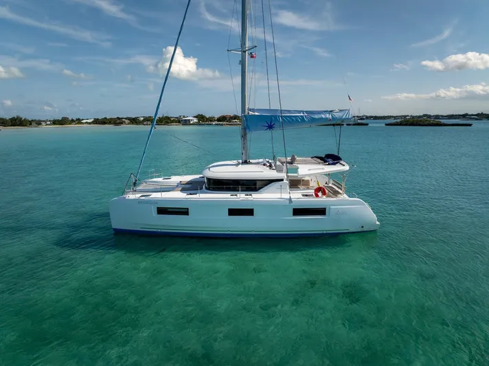 Watercolor Yacht Photos Pics 2023 Lagoon 46 catamaran sailing in clear turquoise waters under a blue sky.