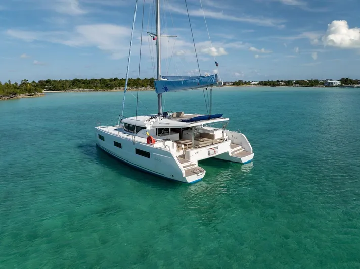 Watercolor Yacht Photos Pics 2023 Lagoon 46 catamaran sailing in clear turquoise waters near a tropical island.