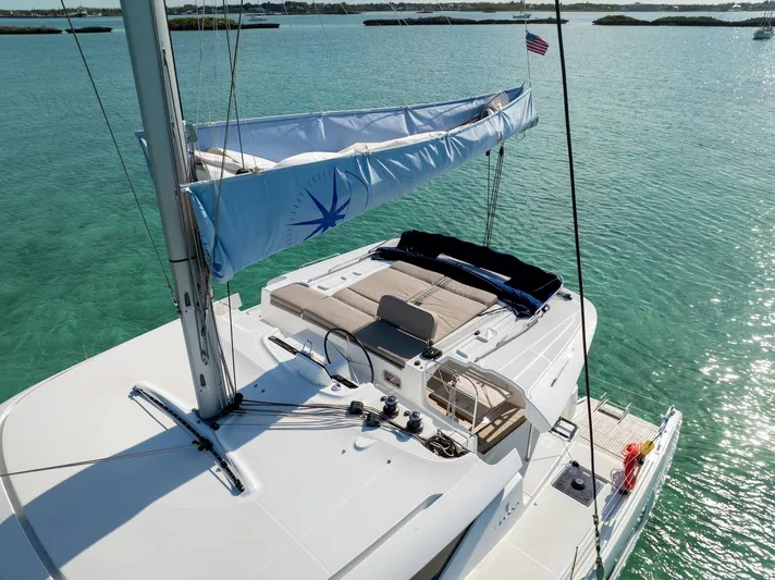 Watercolor Yacht Photos Pics 2023 Lagoon 46 catamaran sailing on clear turquoise waters, featuring a spacious deck.