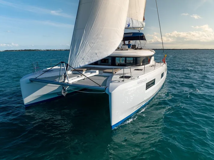 Watercolor Yacht Photos Pics 2023 Lagoon 46 catamaran sailing on open sea under clear skies.