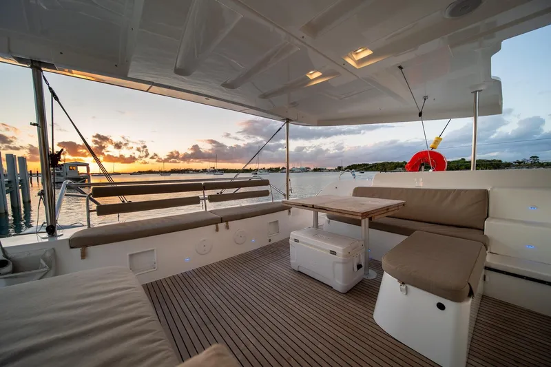Watercolor Yacht Photos Pics Luxurious 2023 Lagoon 46 yacht deck at sunset, featuring comfortable seating and elegant design.