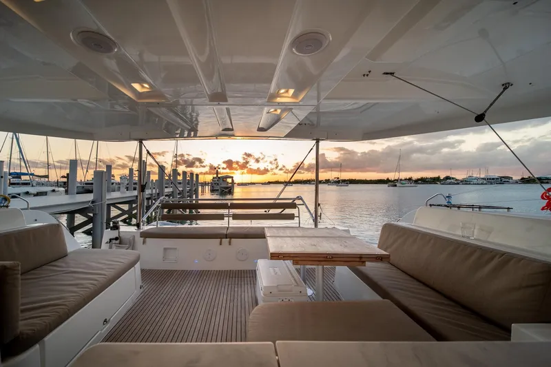Watercolor Yacht Photos Pics Luxurious Lagoon 46 catamaran interior with sunset view, 2023 model, featuring comfortable seating and elegant design.