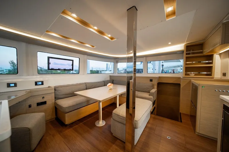 Watercolor Yacht Photos Pics Luxurious interior of 2023 Lagoon 46 catamaran with modern seating and dining area.