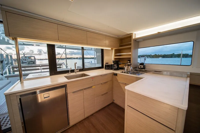 Watercolor Yacht Photos Pics Modern kitchen interior of 2023 Lagoon 46 yacht with ocean view.