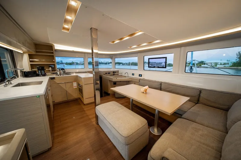 Watercolor Yacht Photos Pics Luxurious interior of 2023 Lagoon 46 catamaran with modern kitchen and spacious seating area.