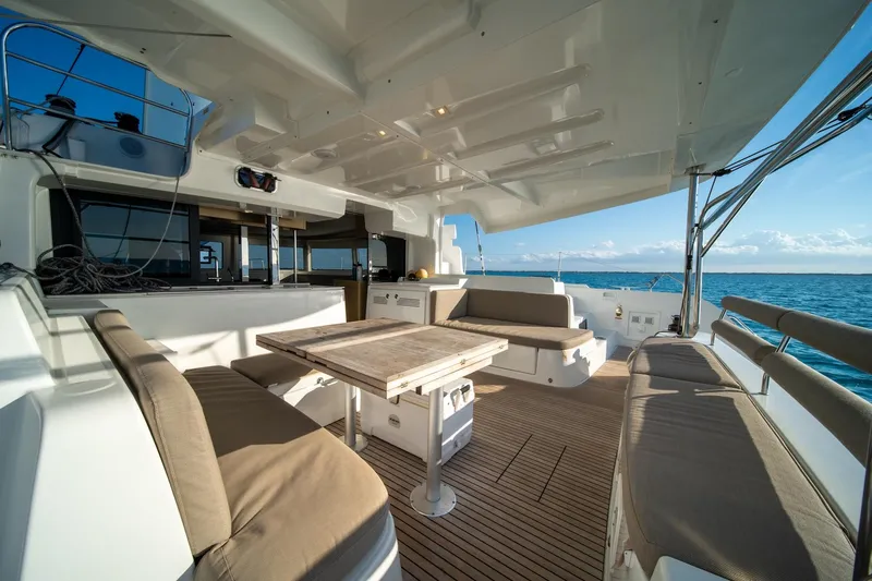 Watercolor Yacht Photos Pics Luxurious 2023 Lagoon 46 yacht deck with seating and ocean view.