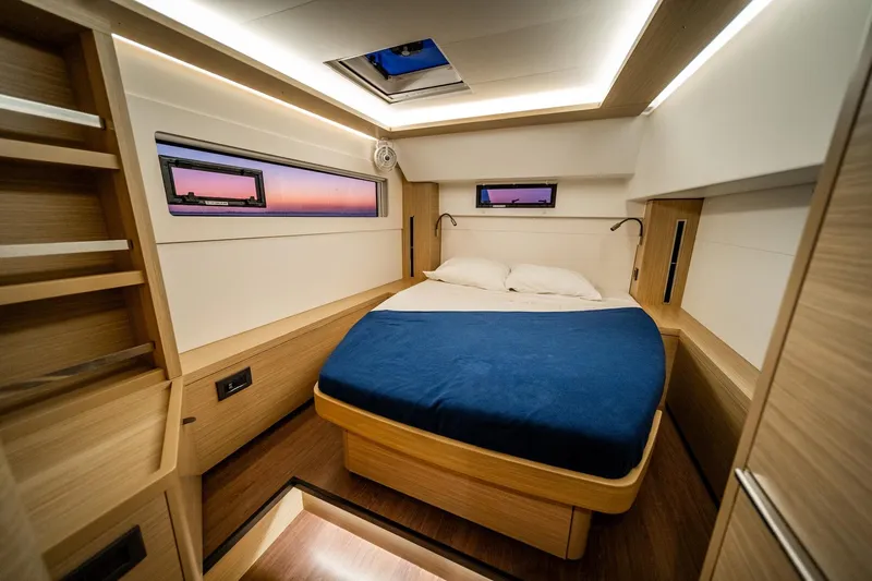 Watercolor Yacht Photos Pics Luxurious interior cabin of 2023 Lagoon 46 yacht with modern design and cozy bedding.