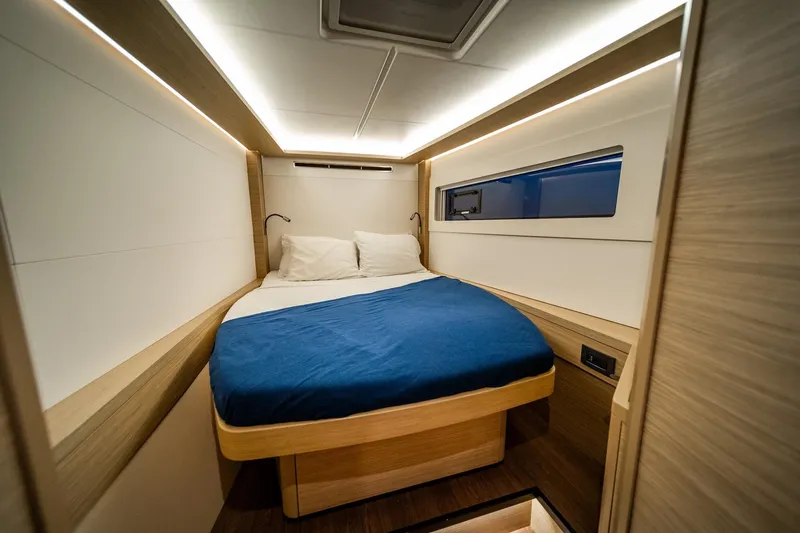 Watercolor Yacht Photos Pics 2023 Lagoon 46 yacht cabin with modern design, cozy bed, and ambient lighting.