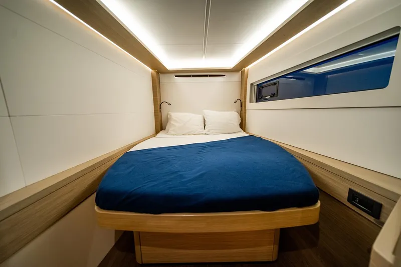 Watercolor Yacht Photos Pics 2023 Lagoon 46 yacht cabin with modern design, cozy bed, and ambient lighting.