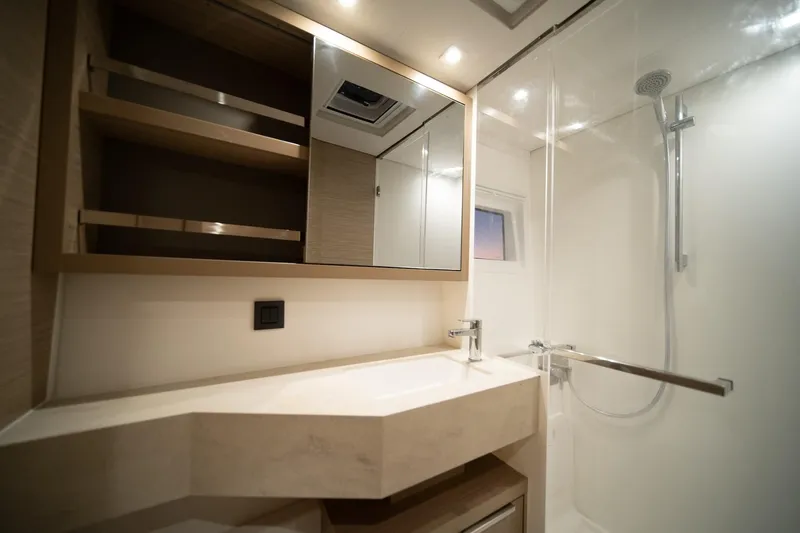 Watercolor Yacht Photos Pics Modern bathroom in 2023 Lagoon 46 yacht with sleek fixtures and ample storage.