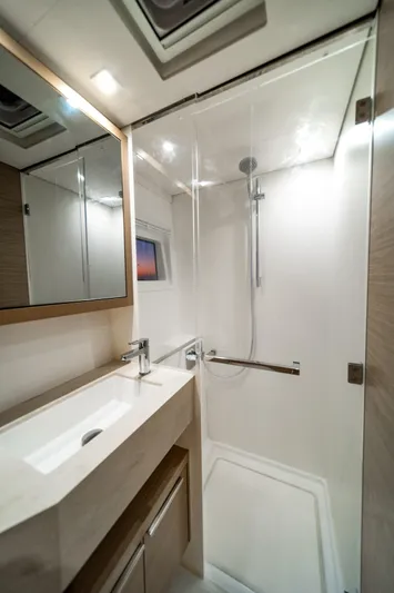Watercolor Yacht Photos Pics Modern bathroom in 2023 Lagoon 46 yacht with sleek shower and vanity.