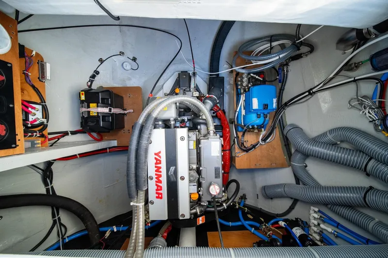 Watercolor Yacht Photos Pics Engine room of 2023 Lagoon 46 yacht with Yanmar engine and various mechanical components.