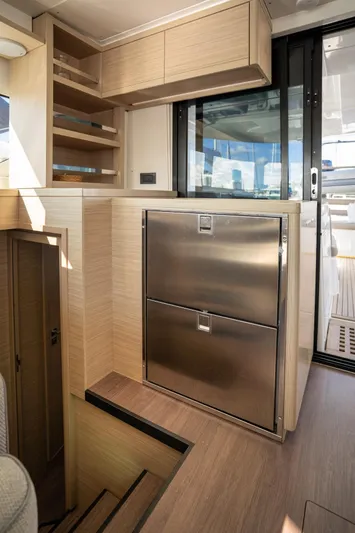 Watercolor Yacht Photos Pics Modern interior of 2023 Lagoon 46 yacht with sleek cabinetry and stainless steel appliances.