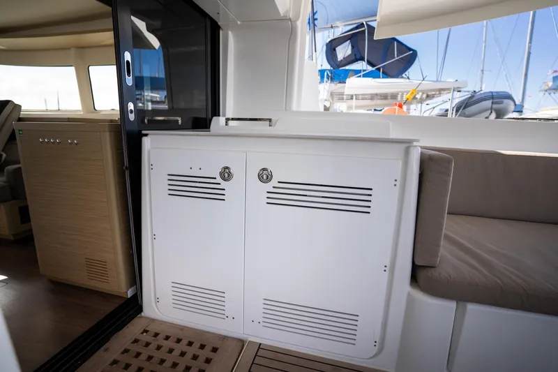 Watercolor Yacht Photos Pics 2023 Lagoon 46 yacht interior with seating and storage area.