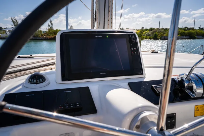 Watercolor Yacht Photos Pics Cockpit of 2023 Lagoon 46 catamaran with navigation display and controls.