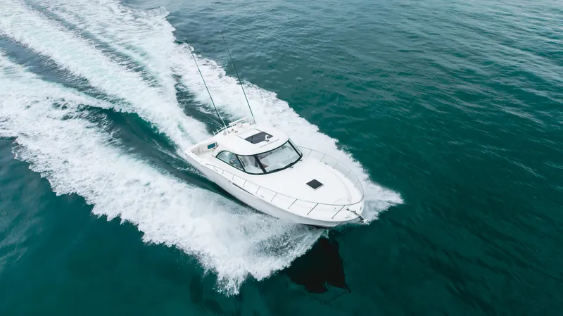 Commodore Two Yacht Photos Pics 2023 Mag Bay 42 Express cruising on open water, aerial view.