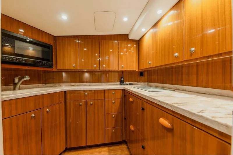 Miss Peggy Sue II Yacht Photos Pics Luxurious wooden kitchen interior of 2018 Viking 44 Open yacht with modern amenities.