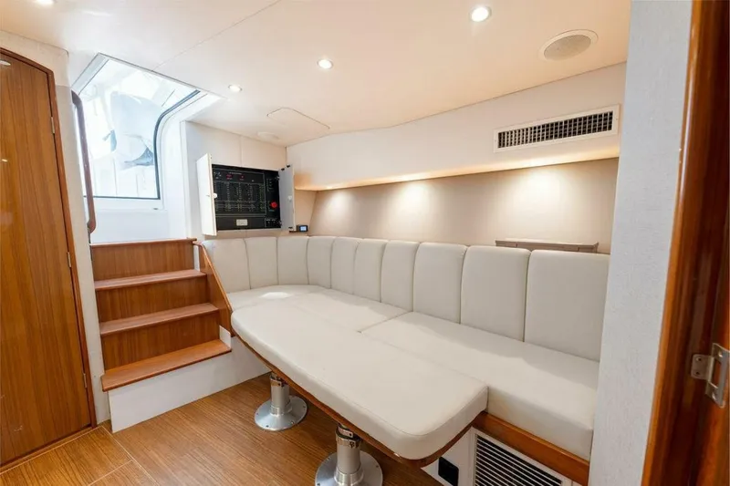 Miss Peggy Sue II Yacht Photos Pics Luxurious interior of 2018 Viking 44 Open yacht with plush seating and wooden accents.