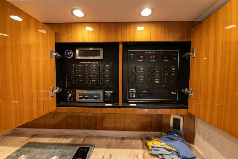 Miss Peggy Sue II Yacht Photos Pics Electrical panel inside 2018 Viking 44 Open yacht, featuring wooden cabinetry and modern controls.