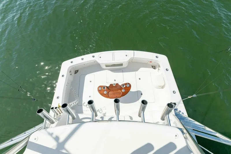 Miss Peggy Sue II Yacht Photos Pics 2018 Viking 44 Open boat deck with fishing rod holders on calm water.