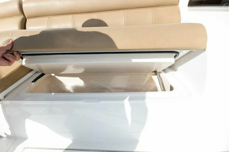 Miss Peggy Sue II Yacht Photos Pics Open storage compartment on 2018 Viking 44 Open boat with beige seating.