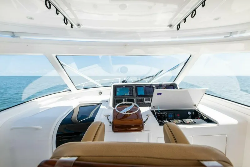 Miss Peggy Sue II Yacht Photos Pics Interior view of 2018 Viking 44 Open yacht helm with ocean backdrop.