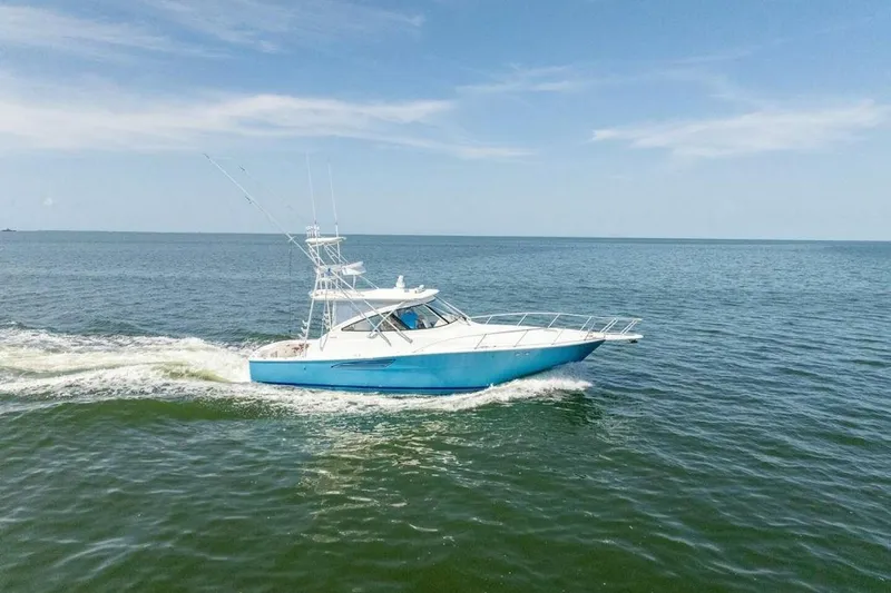 Miss Peggy Sue II Yacht Photos Pics 2018 Viking 44 Open yacht cruising on open sea under clear blue sky.
