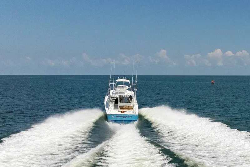 Miss Peggy Sue II Yacht Photos Pics 2018 Viking 44 Open yacht cruising on open sea, leaving a wake.