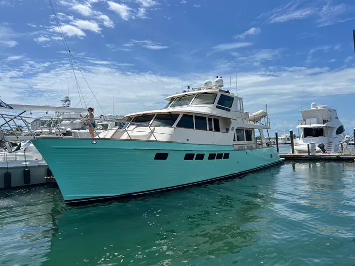 Novia II Yacht Photos Pics 2020 Marlow Explorer 66E yacht docked in a marina under a clear blue sky.