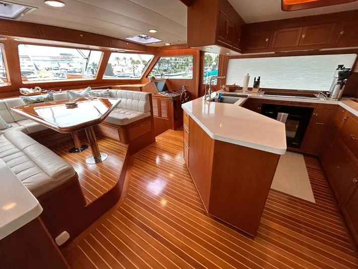 Novia II Yacht Photos Pics Luxurious interior of 2020 Marlow Explorer 66E yacht with elegant wood finishes and modern kitchen.