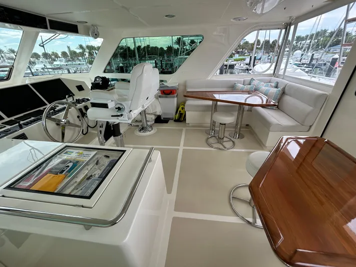 Novia II Yacht Photos Pics Luxurious interior of 2020 Marlow Explorer 66E yacht with helm and seating area.