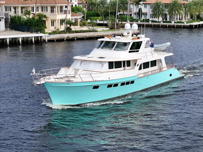 Novia II Yacht Photos Pics 2020 Marlow Explorer 66E yacht cruising on a scenic waterfront.