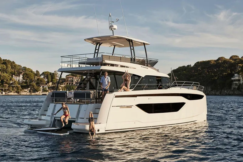 M3400 Yacht Photos Pics Manufacturer Provided Image: Luxury Prestige M48 yacht 2025 on serene water with people enjoying the sun.