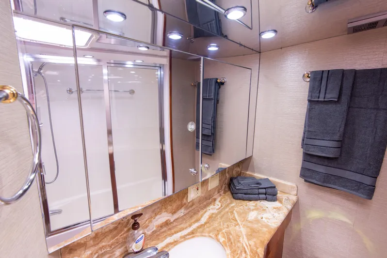 Rayne Check Yacht Photos Pics Luxurious bathroom in 2001 Hatteras 65 yacht with marble countertop and modern fixtures.