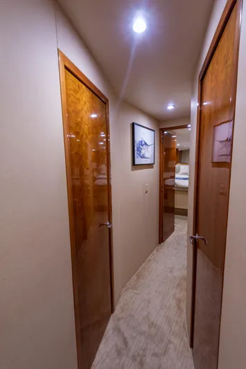 Rayne Check Yacht Photos Pics Hallway inside 2001 Hatteras 65 yacht with wooden doors and soft lighting.