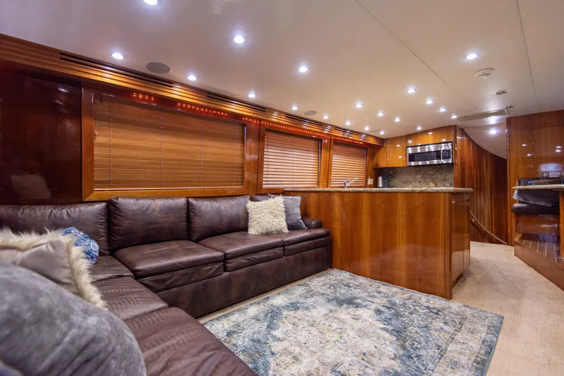 Rayne Check Yacht Photos Pics Luxurious interior of 2001 Hatteras 65 yacht with leather seating and modern kitchen.