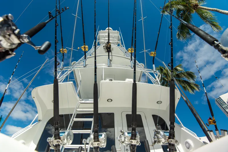 Rayne Check Yacht Photos Pics Fishing rods on a 2001 Hatteras 65 yacht against a clear blue sky.