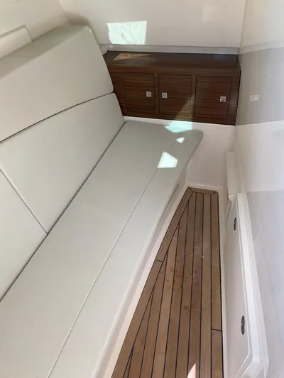 2023 Boston Whaler 320vantage @ Puerto Vallarta Yacht Photos Pics Interior of 2023 Boston Whaler 320 Vantage with wooden flooring.