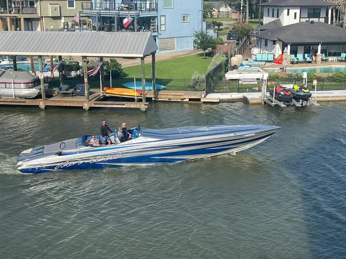  Yacht Photos Pics 2013 Nor-Tech 477 SPX Vee Bottom boat cruising on a sunny waterfront.