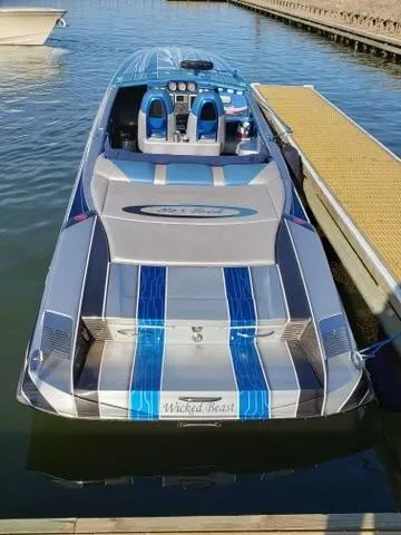  Yacht Photos Pics 2013 Nor-Tech 477 SPX Vee Bottom boat docked, featuring sleek design and blue accents.